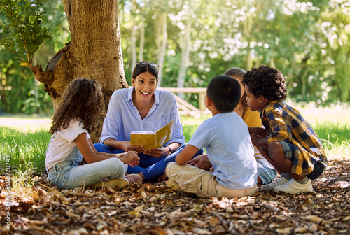 Photography Teacher reading, tree or children with book for learning development, storytelling or growth in park