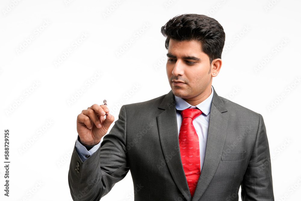 Young businessman pointing in front of with pen Young businessman pointing in front of with pen