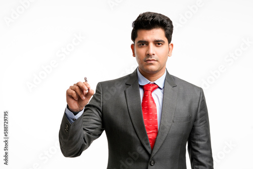 Young businessman pointing in front of with pen