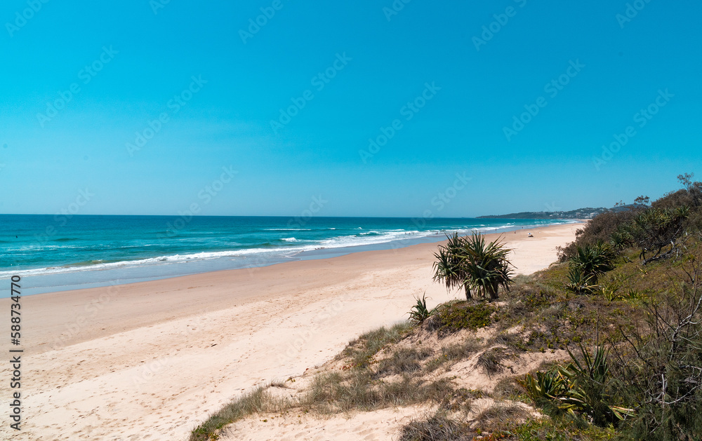 Beautiful wide panoramic view of the Peregian beach with rolling waves of Pacific ocean, Sunshine Coast, Queensland, Australia.