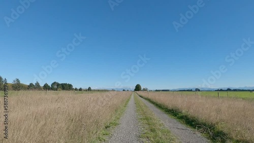 POV Off-Road Cycling in summertime with farmland and foothills in distance - Selwyn District, New Zealand photo