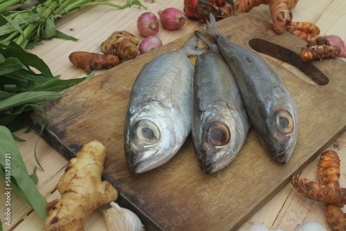 Raw mackerel fish with ingredients for cookingSelective focus. Top view.
 photo