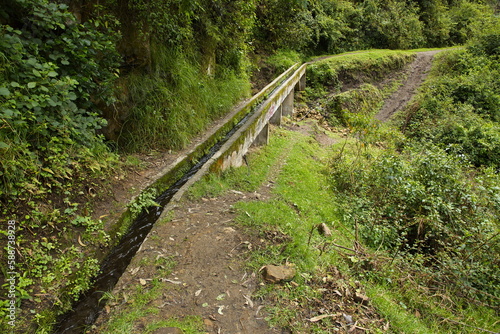 Water canal under the waterfall Cascada de Peguche in the northeast of Otavalo, Ecuador, South America 