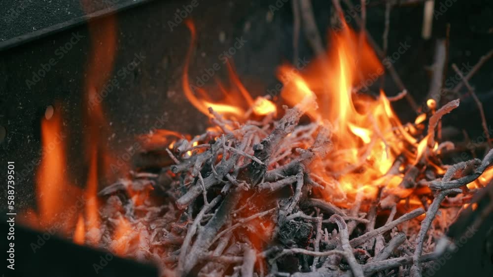 Close-up barbecue fire burning outdoors. High angle view red flame in camping picnic Close-up barbecue fire burning outdoors. High angle view red flame in camping picnic