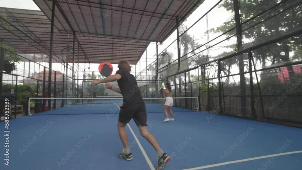 People play tennis outdoor court slow motion. Young adult player serve ball opponent. Racket sport game match. Athlete team hit workout outside arena. Sportsman health care. Woman person fit exercise.