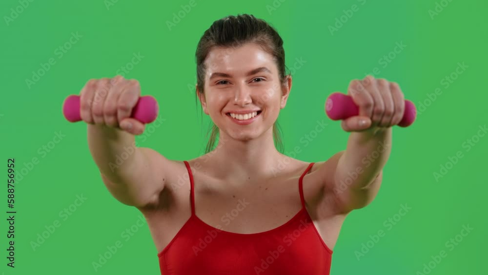 woman lifting dumbells for strong arms dressed red top and sports leggings Isolated on Green Screen studio woman lifting dumbells for strong arms dressed red top and sports leggings Isolated on Green Screen studio