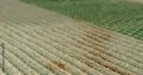 Stain spot from spilled coffee or wine on white rug sofa cloth close-up. Spoiled linen, spilling drink on clothes slow motion shot. Laundry concept, household chores and cleaning service. photo