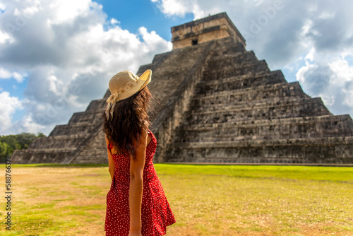 Beautiful tourist observing the old pyramid and temple of the castle of the Mayan architecture known as Chichen Itza these are the ruins of this ancient pre-columbian civilization and part of humanity photo