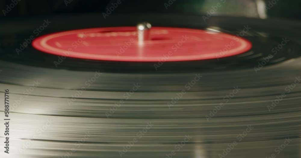 Retro Vinyl record player playing music, close-up macro shot of vintage LP disc old phonograph spinning. Retro music player at home. Retro Vinyl record player playing music, close-up macro shot of vintage LP disc old phonograph spinning. Retro music player at home.