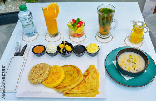 Moroccan breakfast tea and orange juice. pastries. oil. Butter and topping