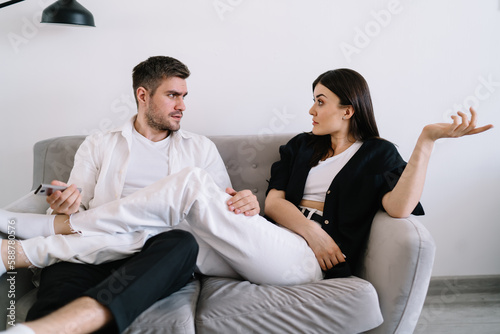 Fototapeta Naklejka Na Ścianę i Meble -  Serious couple having argument on couch