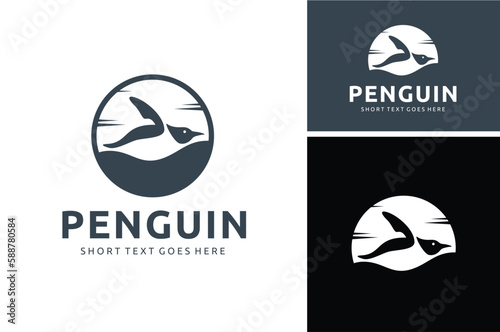 Silhouette of Sliding Penguin with Horizon Background for Antarctic coasts wildlife logo design photo