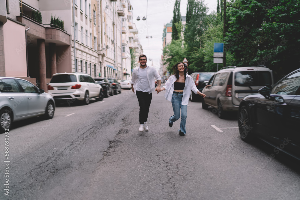 Happy couple running on street Happy couple running on street