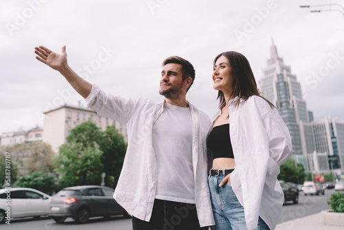 Smiling man showing city to girlfriend