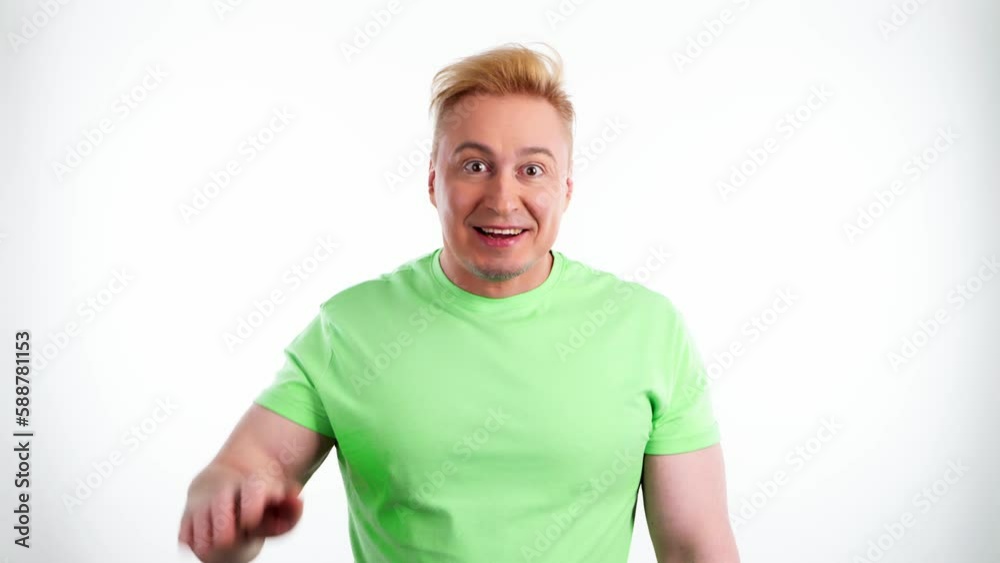 Greeting, wave and say hello or welcome with man friendly confident. Hand waving gesture and expressive smiling guy saying hi or goodbye wears green t-shirt in studio shot isolated on white background Greeting, wave and say hello or welcome with man friendly confident. Hand waving gesture and expressive smiling guy saying hi or goodbye wears green t-shirt in studio shot isolated on white background