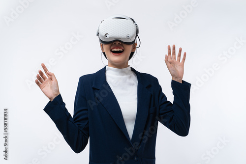 Happy young Asian businesswoman working in virtual reality environment in VR glasses touching virtual interface isolated on white background.