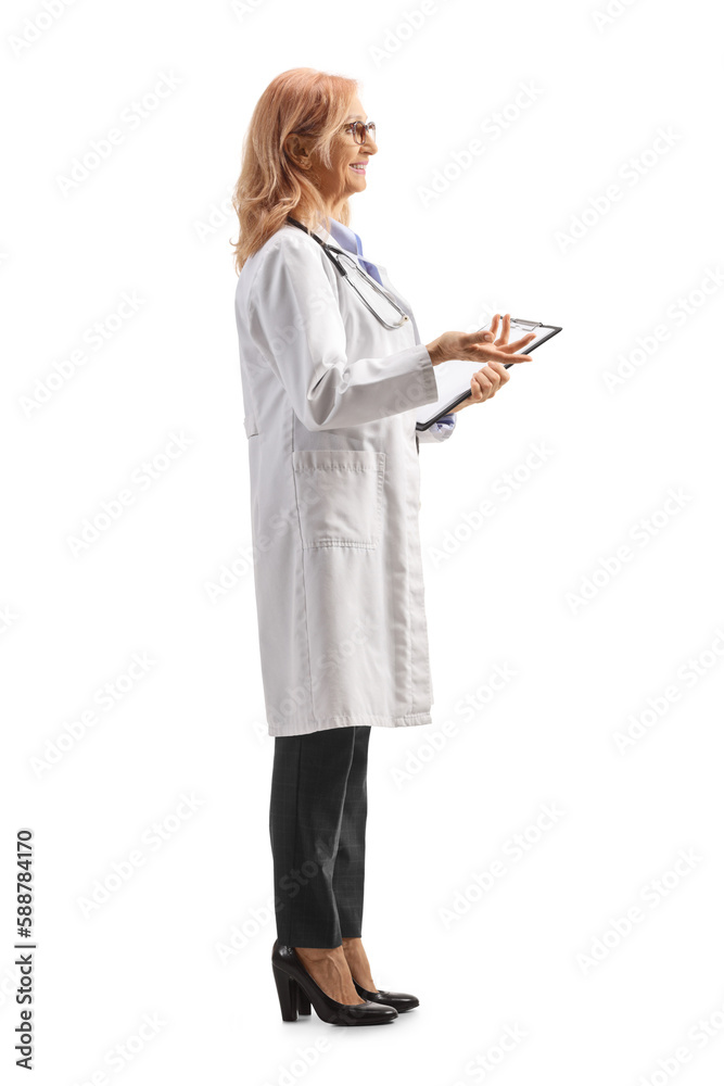 Full length profile shot of a female doctor holding a clipboard and explaining something with hand Full length profile shot of a female doctor holding a clipboard and explaining something with hand