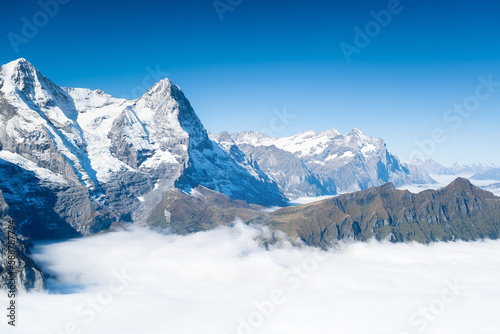 Mountain scenery in the Swiss Alps. Mountains peaks. Natural landscape. Mountain range and clear blue sky. Landscape in the summertime.