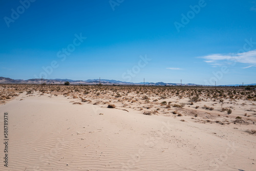 dirt road in the desert with blue sky