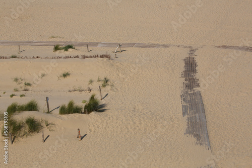 Plank footpath on the beach seen from above
