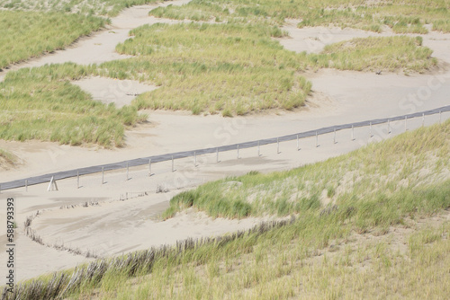 Plank footpath through the dunes seen from above
