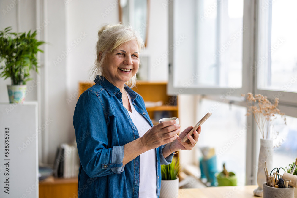 Smiling senior woman using smartphone 
