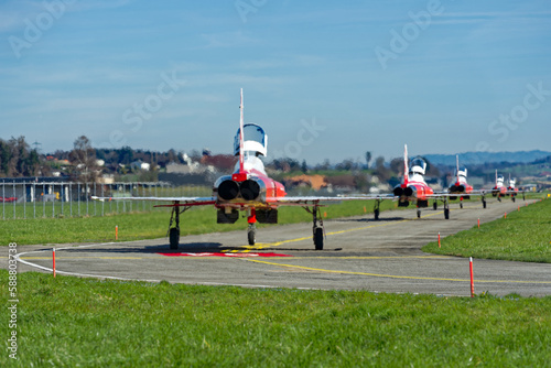 Foto Red and white Northrop F-5E Tiger II fighter of Patrouille Suisse taxiing to hangar at Swiss Air Force airbase Emmen, Canton Luzern