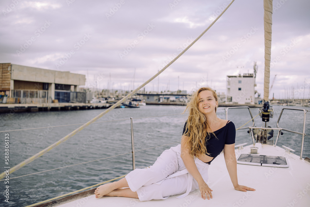 The girl rests on a yacht, a trip to the ocean The girl rests on a yacht, a trip to the ocean