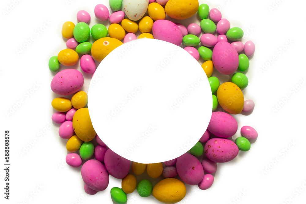 Multicolored dragees and chocolate eggs in the shape of a circle with space for text Multicolored dragees and chocolate eggs in the shape of a circle with space for text