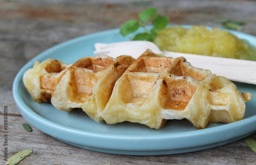 Waffle and pineapple jam on blue plate Waffle and pineapple jam on blue plate