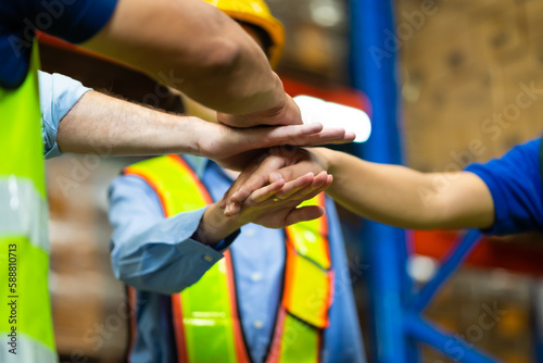 Hand stacking. Unity and teamwork concept. team standing hands together. Professional Mechanical Engineer team Working at warehouse store.