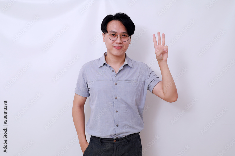 Happy Asian man standing while showing three fingers. Isolated on white background Happy Asian man standing while showing three fingers. Isolated on white background
