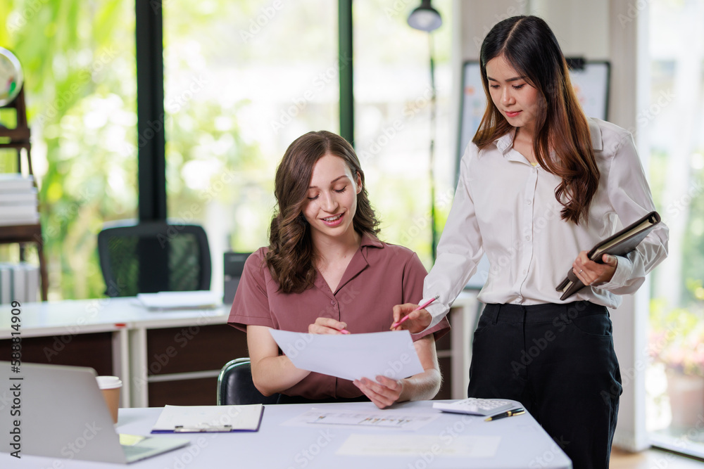 Concept of business office woman working,Businesswoman smile while working about her invesment plan with analyzing document and business investment graph data by using laptop on desk in workstation.