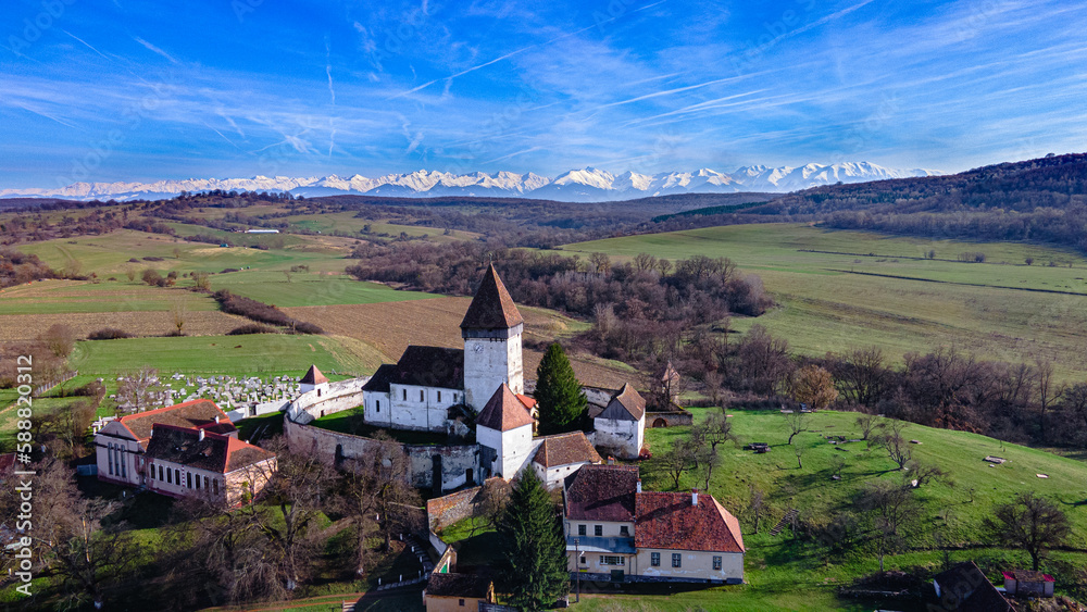 Aerial photography of the fortified church located at Hosman, Sibiu county, Romania. Photography was shot from a drone in mid day with the fortification in the view.