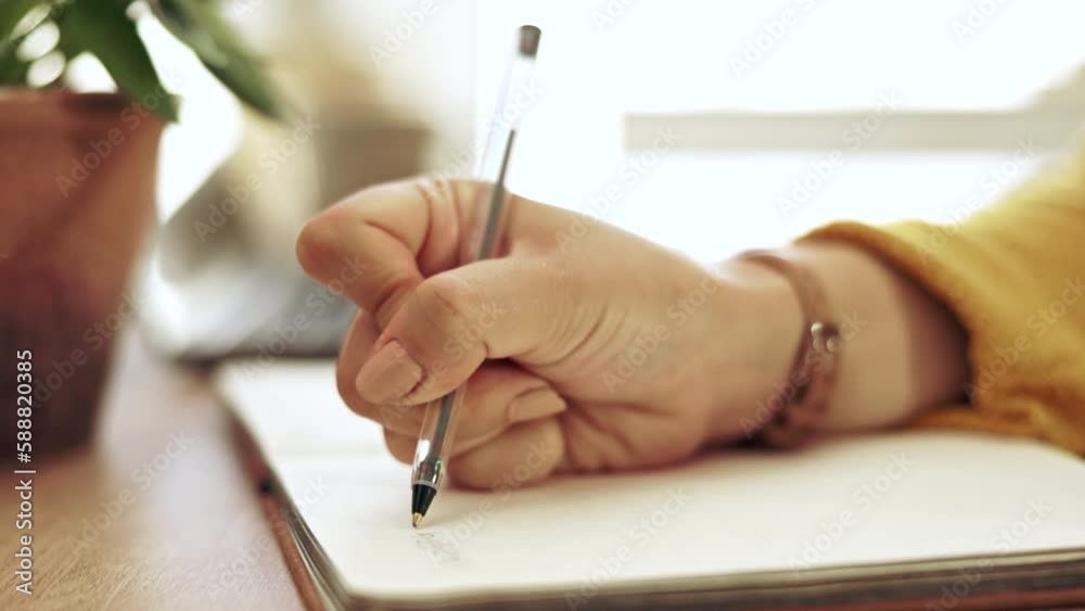 Woman, hand and notebook writing on paper at home working on study schedule and learning plan. Book, notes and house desk with a female student and creative writer busy with studying with a journal