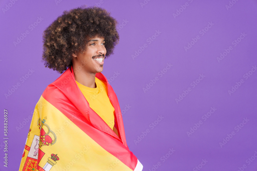 Happy african man wrapping with a spanish flag
