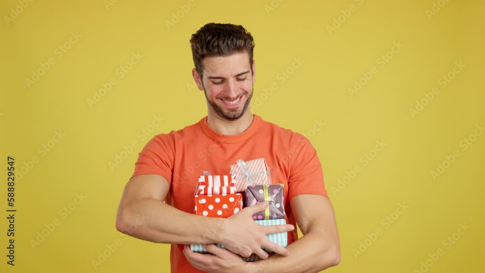 Happy caucasian man holing many colorful gifts Happy caucasian man holing many colorful gifts