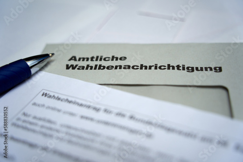 Official election notification (Wahlbenachrichtigung Bundestagswahl) for the federal election in germany. Tip of a ballpoint pen. High angle view. Closeup.