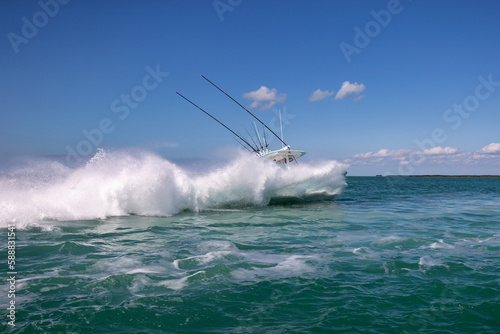 Speeding center console fishing boat hidden behind spray