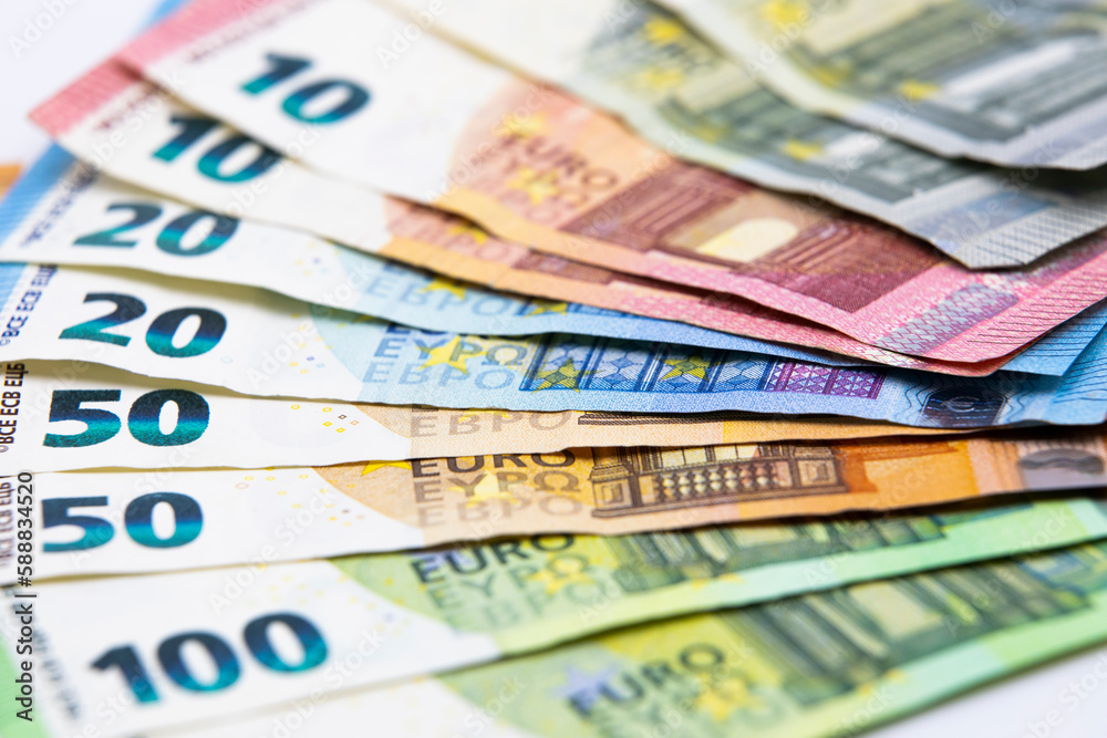 Pile of euro banknotes of 100, 50, 20, 10 and 5 euros. White background Pile of euro banknotes of 100, 50, 20, 10 and 5 euros. White background