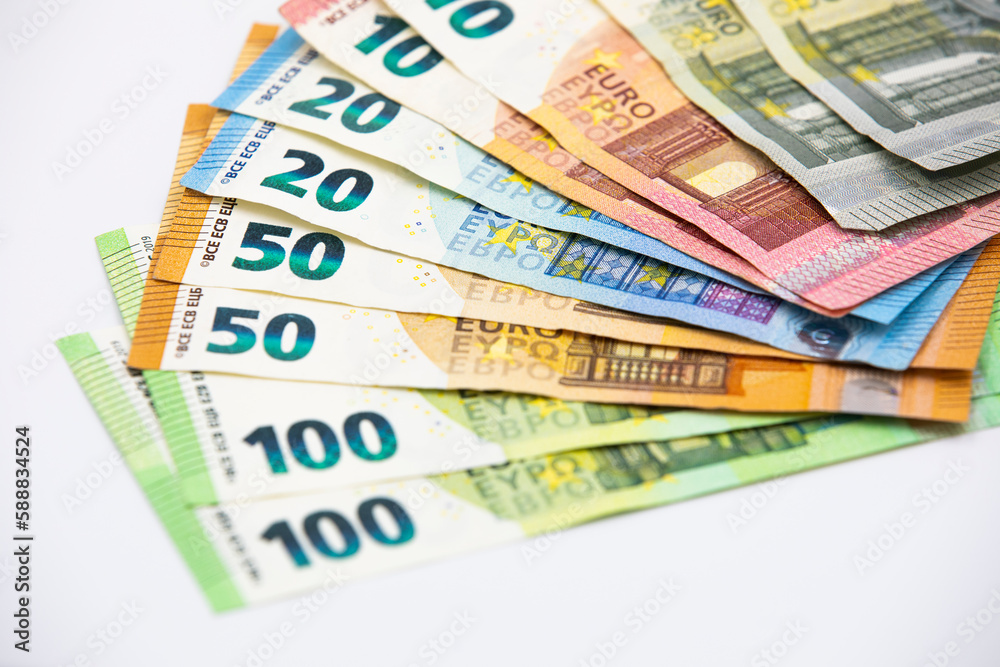 Pile of euro banknotes of 100, 50, 20, 10 and 5 euros. White background Pile of euro banknotes of 100, 50, 20, 10 and 5 euros. White background