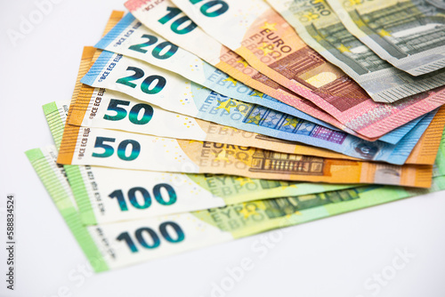 Pile of euro banknotes of 100, 50, 20, 10 and 5 euros. White background