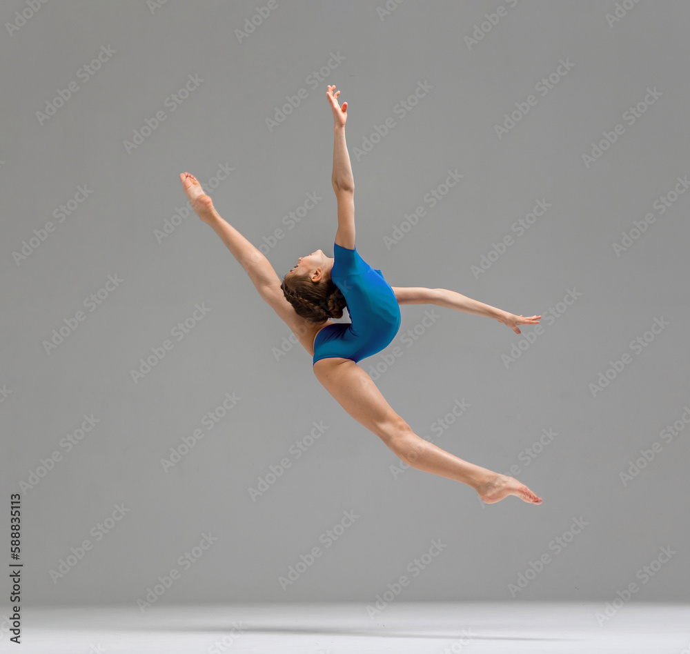 Fototapeta premium Young rhythmic gymnas showing stretch gymnast pose