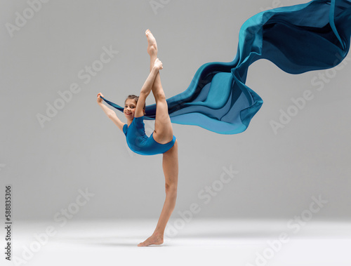 Young rhythmic gymnas showing stretch gymnast pose