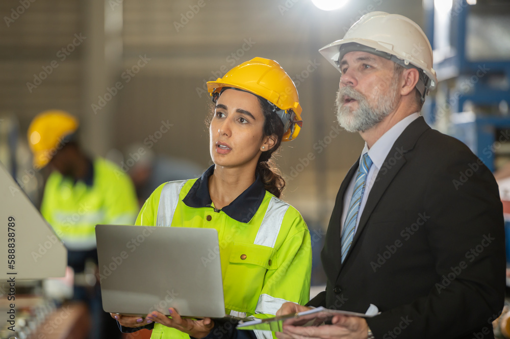 woman engineer assistant secretary in helmet inspection check control heavy machine construction installation in industrial factory with boss manager. Boss and partnership check maintenance factory