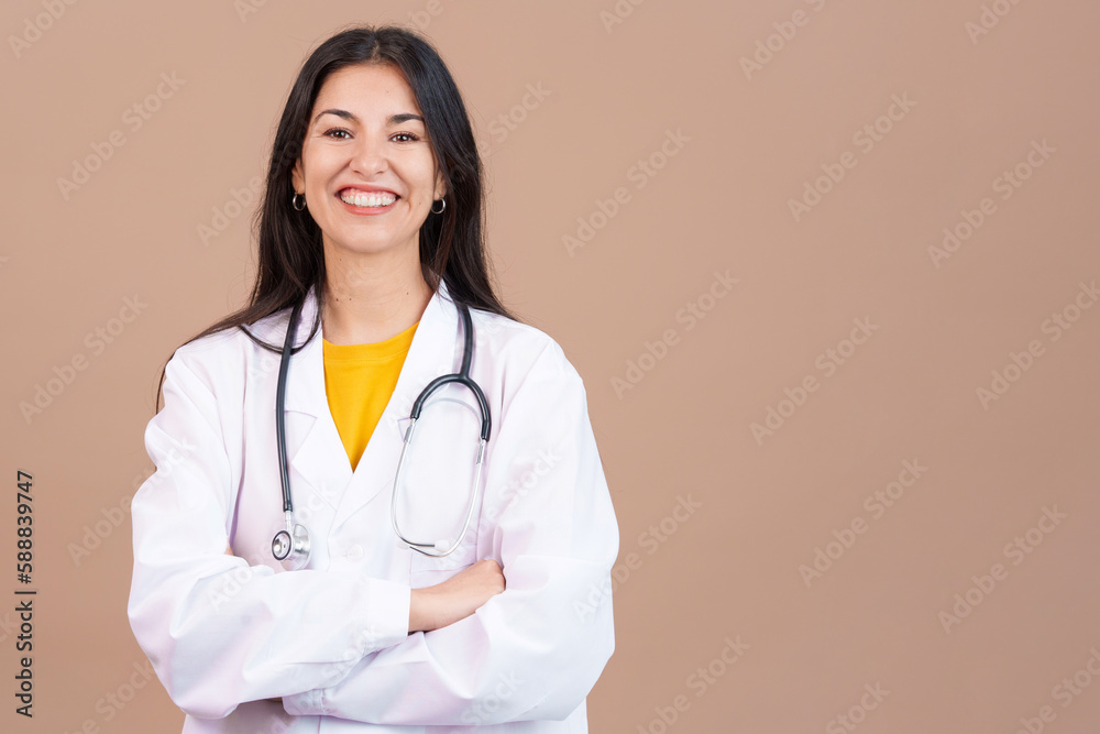 Caucasian female doctor smiling at the camera with arms crossed Caucasian female doctor smiling at the camera with arms crossed