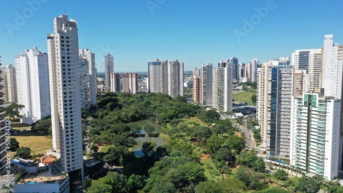 Wonderful panoramic view of Flamboyant Park with lakes and tropical trees surrounded by modern residential apartments in Goiania, Goias, Brazil in April, 2023.  photo