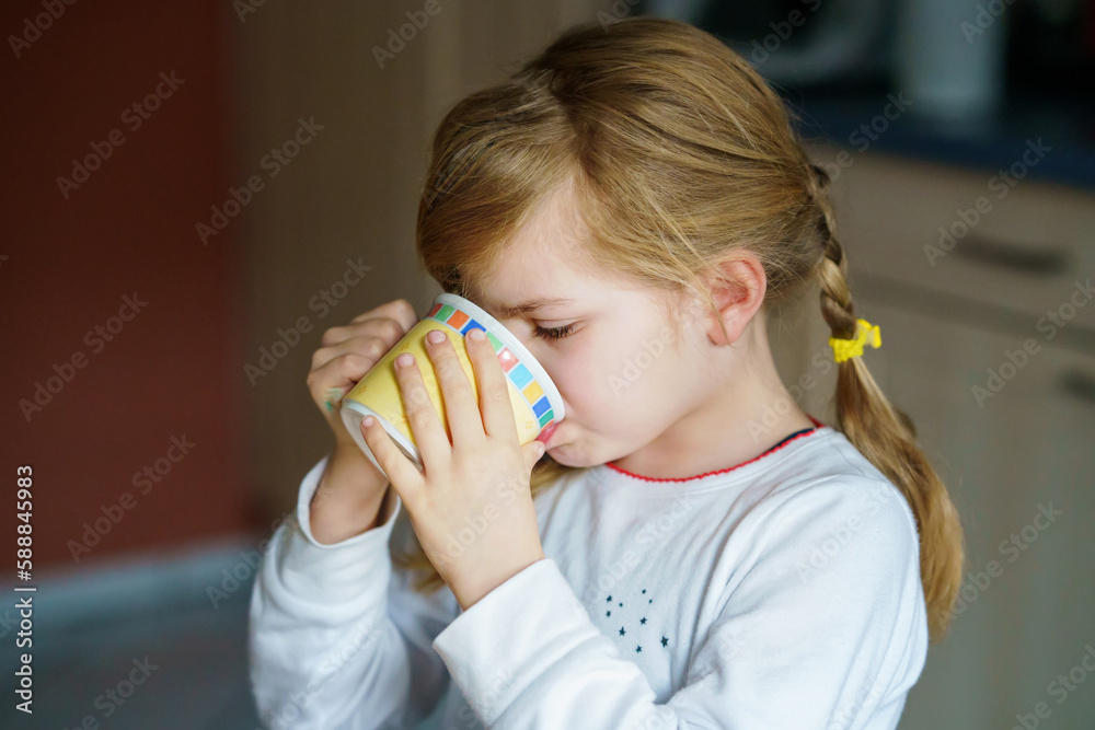 Little smiling girl have a breakfast at home. Preschool child eating sandwich with boiled eggs. Happy children, healthy food and meal. Little smiling girl have a breakfast at home. Preschool child eating sandwich with boiled eggs. Happy children, healthy food and meal.