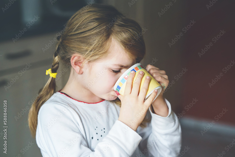 Little smiling girl have a breakfast at home. Preschool child eating sandwich with boiled eggs. Happy children, healthy food and meal. Little smiling girl have a breakfast at home. Preschool child eating sandwich with boiled eggs. Happy children, healthy food and meal.