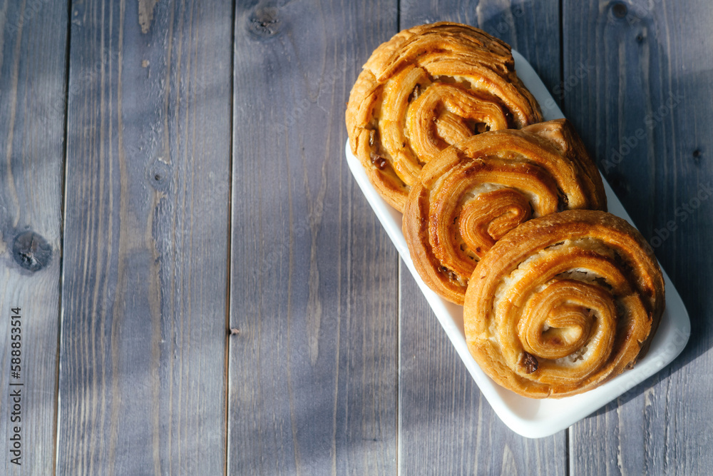 Buns on a wooden background. Break during the day to chat with friends and family over coffee and cake. Buns on a wooden background. Break during the day to chat with friends and family over coffee and cake.